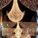 The chandelier lights of Dublin at Christmas time with draped swags of lights on either side across the evening sky
