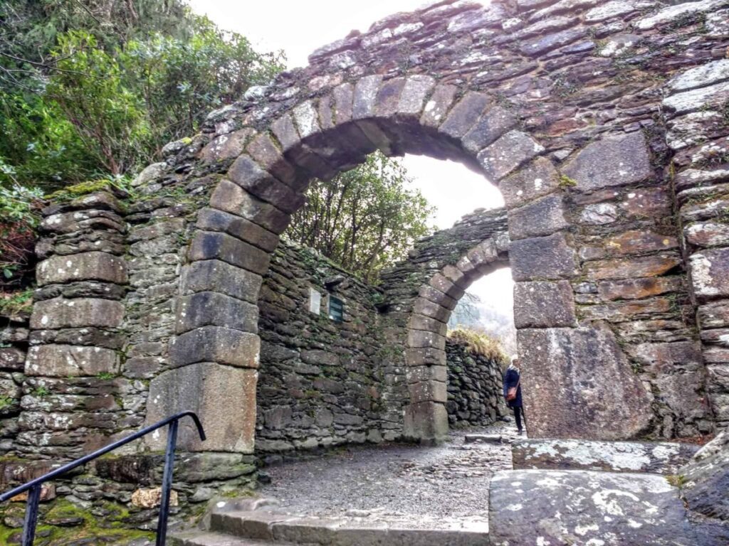 Glendalough gate way the ruined stone arches frame a walkway to the ruined monastery