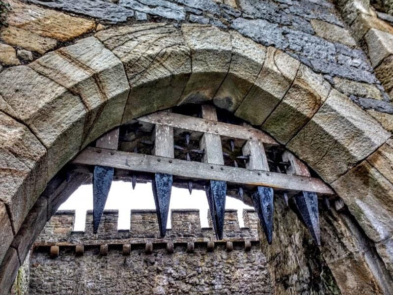 portcullis of Cahir castle this is Ireland's only working portcullis which is a wooden gate with sharp stakes at the end of the gate's vertical slats. Reinforced with steel tips.