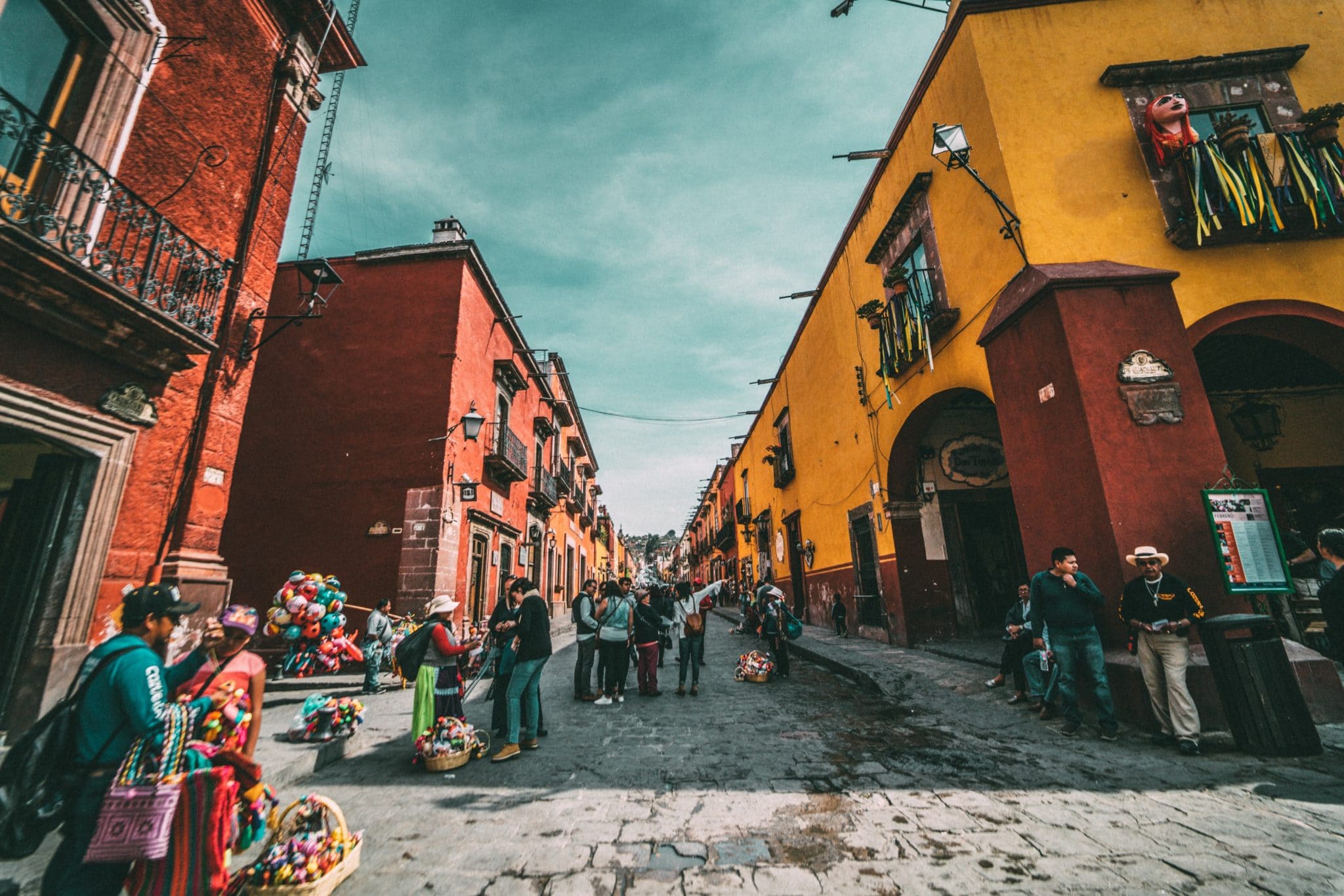 view of a side street in things to do in Merida Mexico with vendors and old colonial buildings
