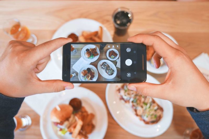 a travel blogger photographing their food, not unusual in most restaurants around the world we foodies travel for unusual food