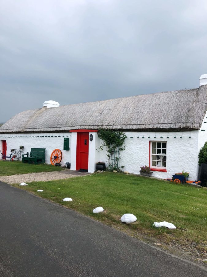 a lovely stone cottage with thatched roof in towns in Ireland 