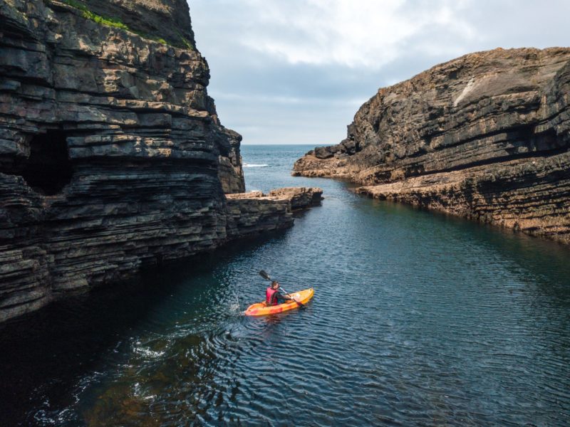 travel to Ireland and go kayaking around the rocks at Dun Briste magical