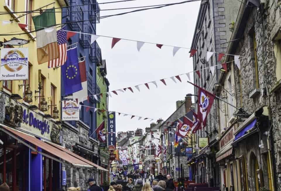 County Galway, Galway City a street of colourful shops with banners flyeing in the town of Galway