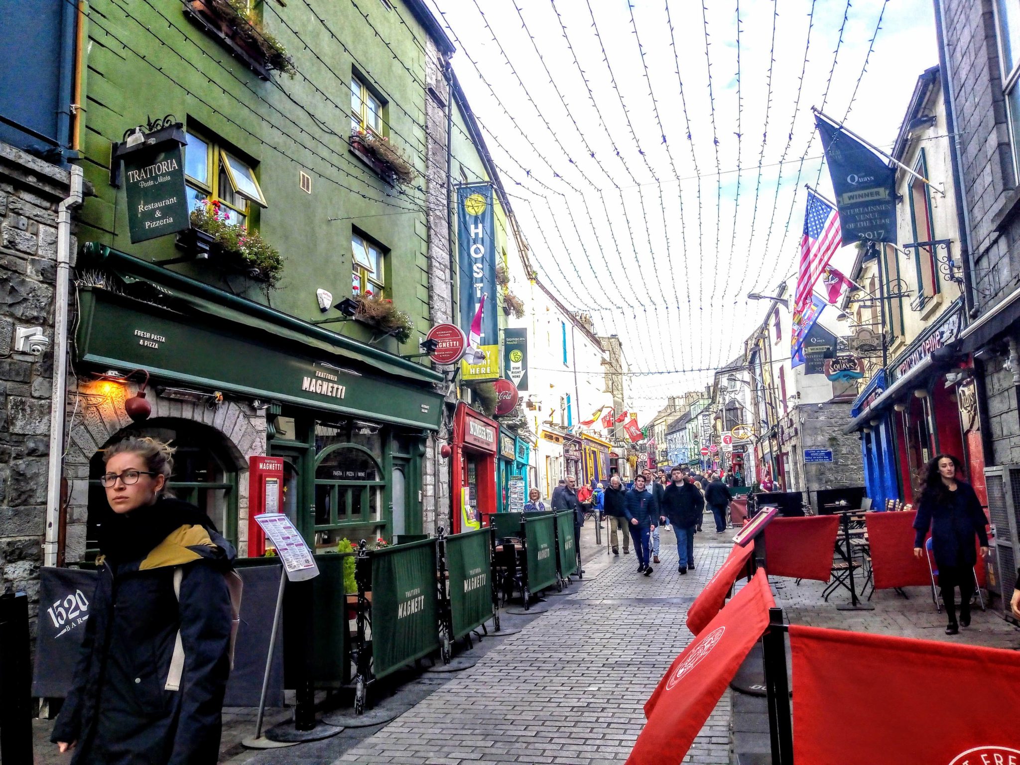 Galway city with shops bars and poeple 