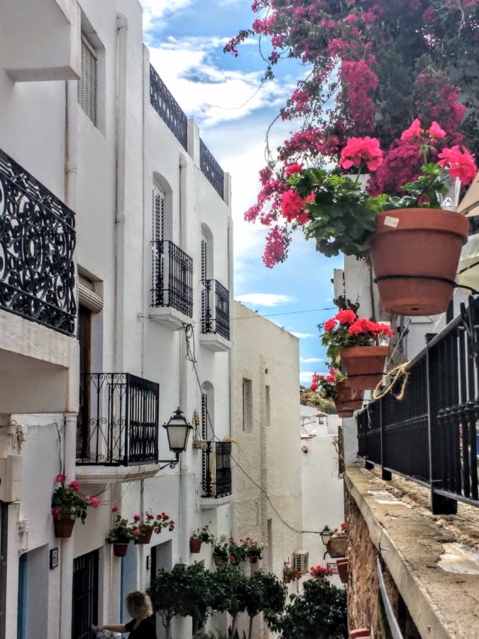 Mojacer Spain streets in the Pueblo Mojácar whitewashed houses with dozens of pots of pink and red geraniums