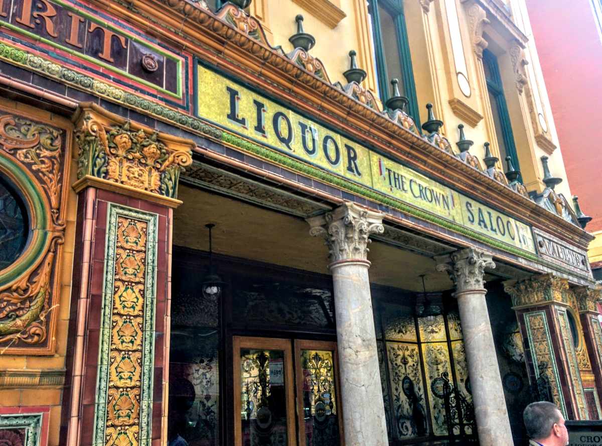 Exterior of the famous Crown Liquor Saloon with Victorian tiled entry way and stained glass windows its interior carved wooden bar, tin ceiling and snugs