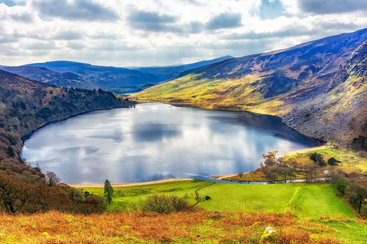 Lough Tay from the Sally Gap in Ireland. Beautiful blue waters surrounded by rolling green hills and mountains.