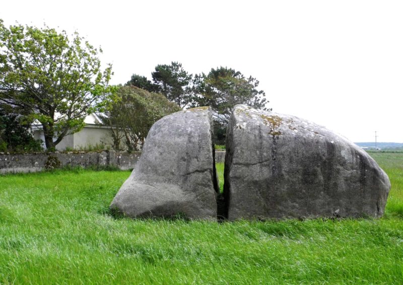 a large spit rock in the middle of a field said to have been split by giants