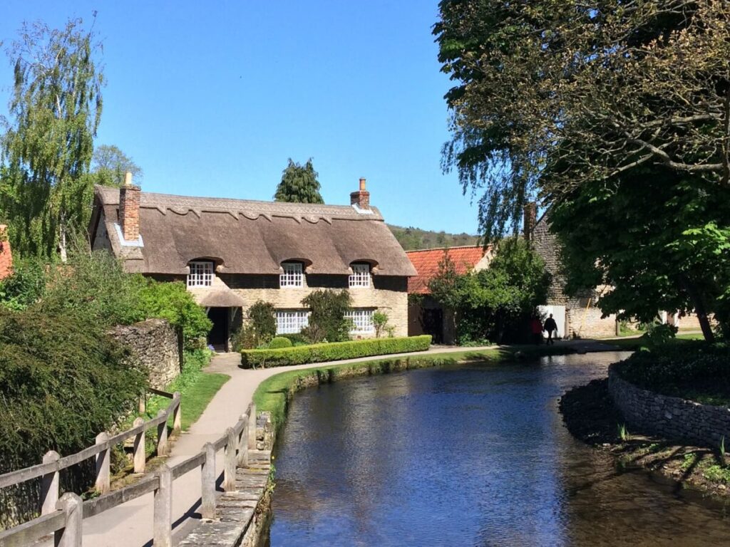 The most photographed house in England is found in Thornton-le-Dale. The house is a thatched roof building facing a narrow path and bridge over the river