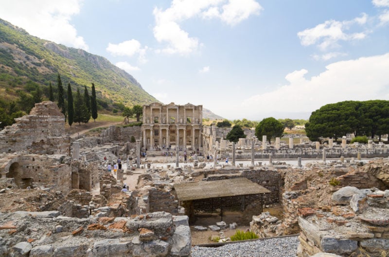 This is the most iconic photographic image taken at Ephesus and the one most associated with Turkey. The Celsus Library was the third largest library in the ancient world, and it held up to 15.000 scrolls. The library building itself sits on top of Celsus's grave or sarcophagus which lies in the crypt below the building.  The statues which can be seen in the various niches at the front of the library symbolize the "virtues" of Celsus and they are Valor, Wisdom, Knowledge, and Intelligence.