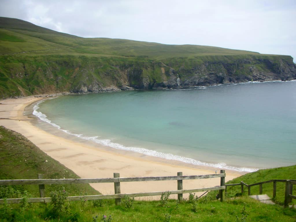 A beautiful stretch of pinky beigh sand in a horseshoe shape at Silver Strand Beach Glencolmcille