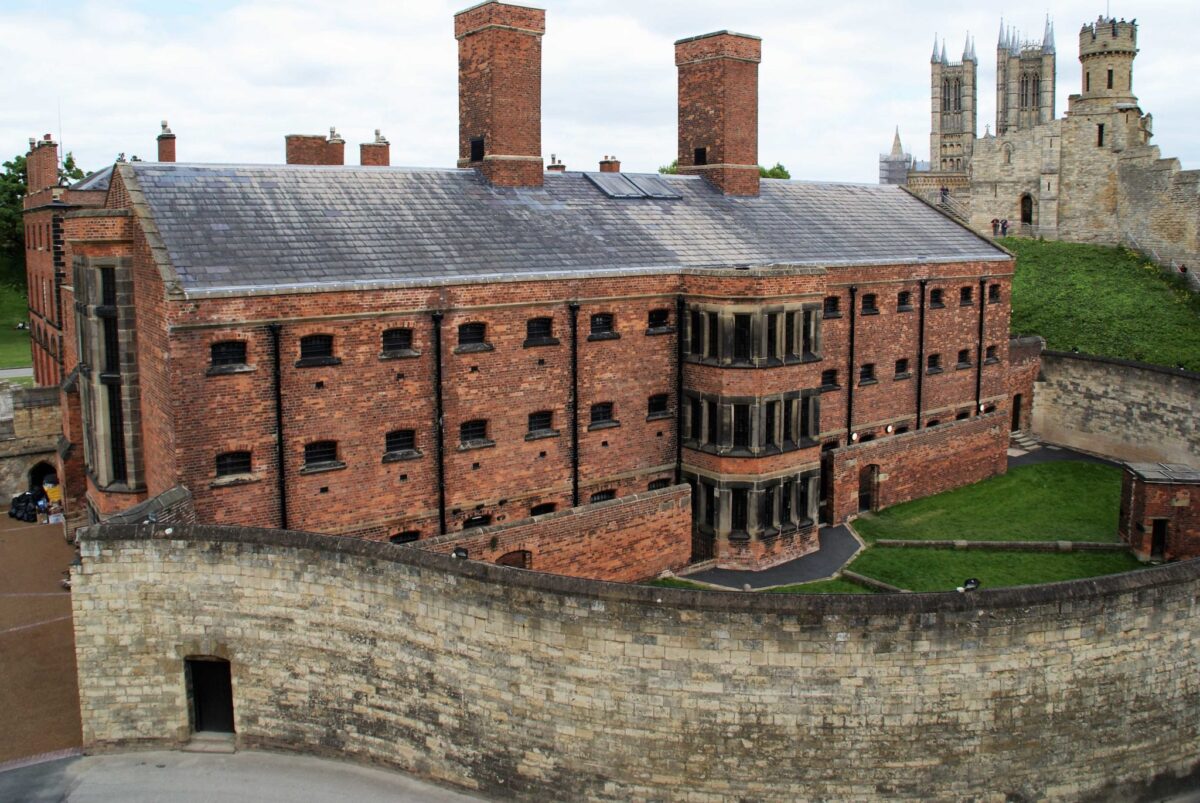 Lincoln Castle a rather grim looking red brick building with a wall around it. It was converted into a prison so the windows are very small with bars and it looks like you would imagine a prison.