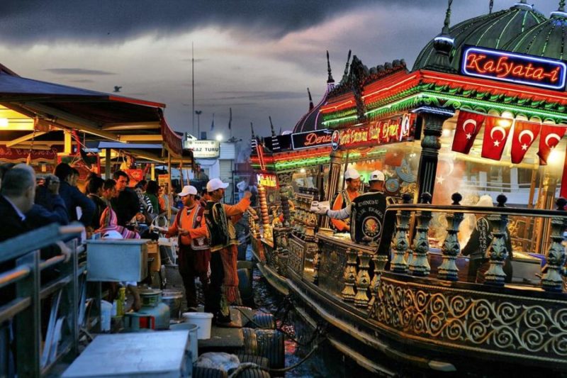 getting a fish sandwich in Turkey from a boat rocking on the Bosphorus