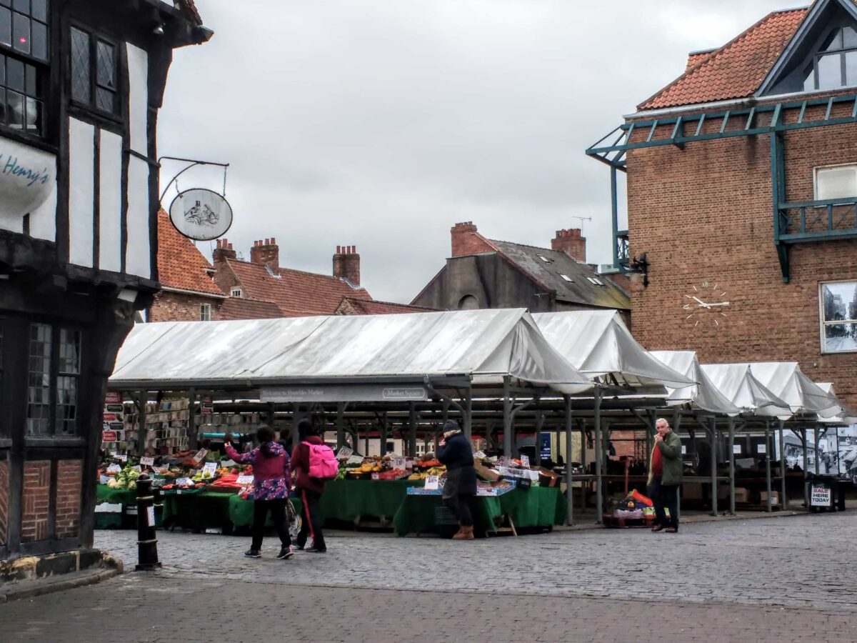 Shambles farmers market with various fruit and veg stalls