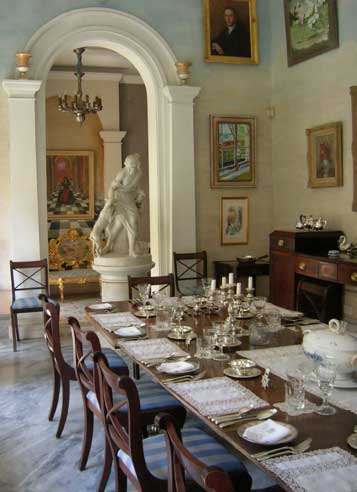 Casa Rocca Piccola a dining room surrounded by paintings, marble columns and sculptures