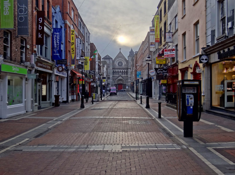 road trip Ireland a view of Dublin at twilight on a city street with Church at far end