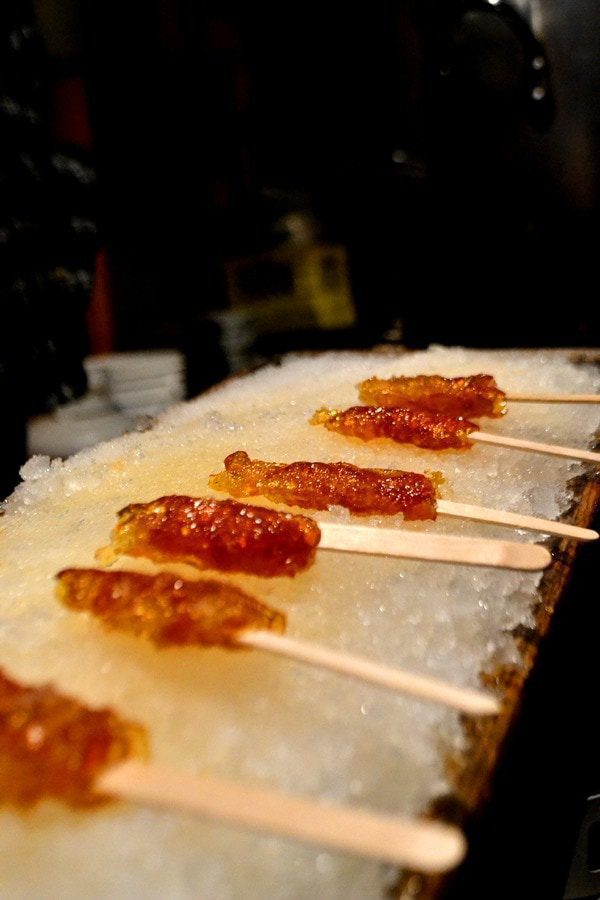 Maple sugar candy on sticks. The golden syrup is hardened by lying it in fresh snow