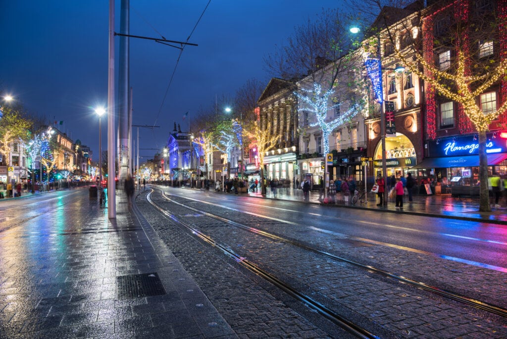 Dublin, Ireland - December 8, 2018: View of O'Connell Street Decorated for Christmas and Crowed with Shoppers and Tourists alike. O’Connell Street is Dublin's main thoroughfare, with some impressive architecture, and the home of the "Spire", the world's tallest sculpture.