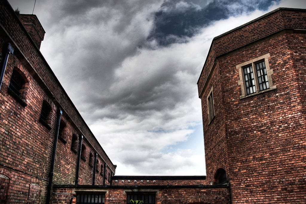 The courtyard of Lincoln Castle looks like a prison. The brick is a blood-red and looks stained with age