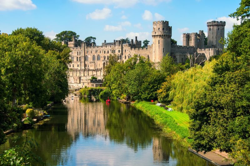 view of Warwick Castle from the riverbank