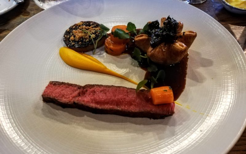 a white plate with a duo of beef and walnut sauce at the Cross Kenilworth