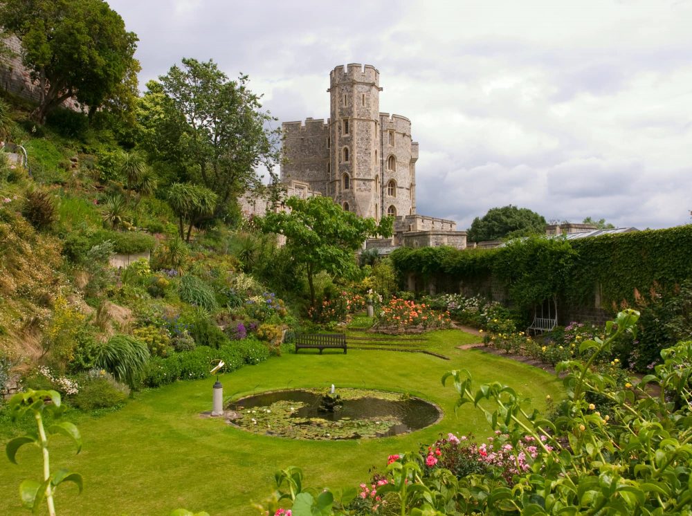 visiting Windsor Castle a view of the beautiful gardens of the castle in summer in full flower.