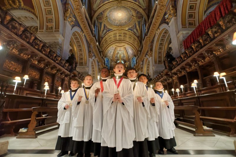 St. Pauls Christmas Card available in the shop a group of choir boys singing in the cathedral of St. Pauls