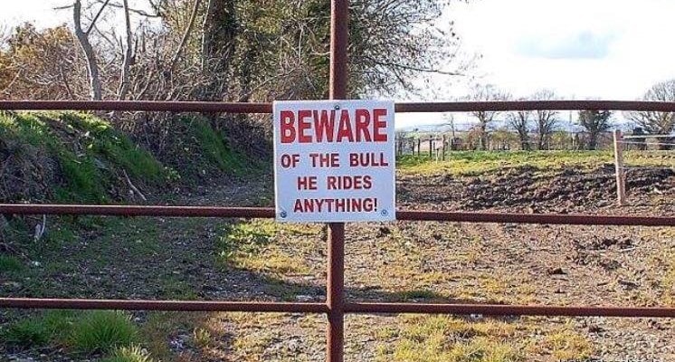 A sign that says beware of the bull, known to gobble anything in its path.