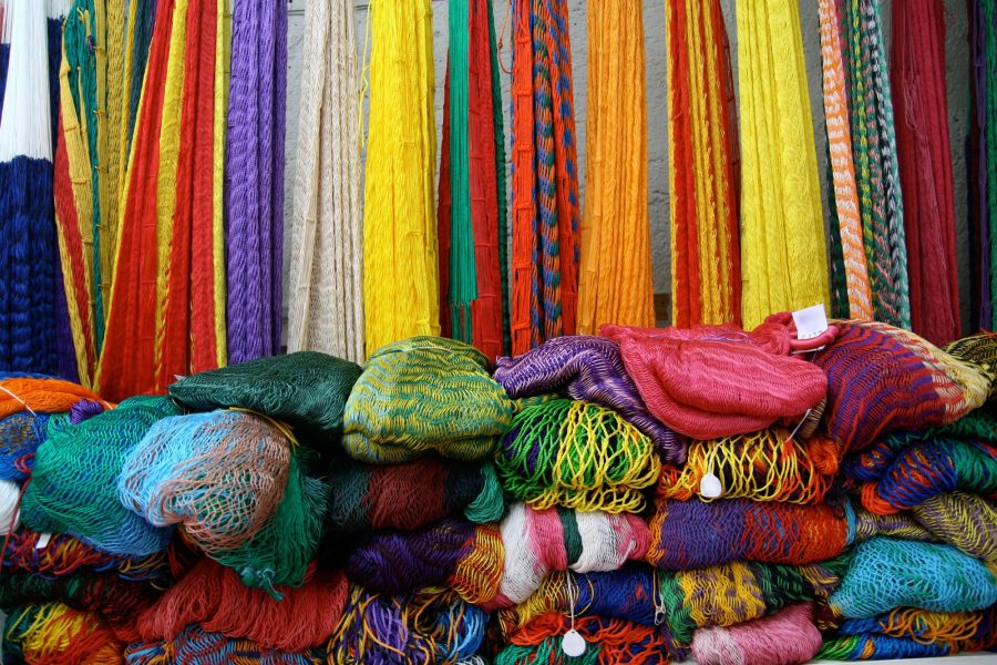 beautiful bright coloured hammocks folded up and for sale at Ebtun Mexico