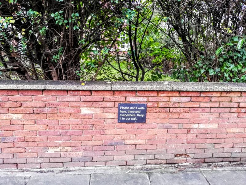 the wall nearby Abbey Road studio covered in Graffitti