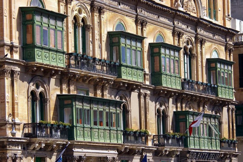 The balconies of Malta, green wooden highly decorated balconies on apartment buildings in Malta - solo travel Malta