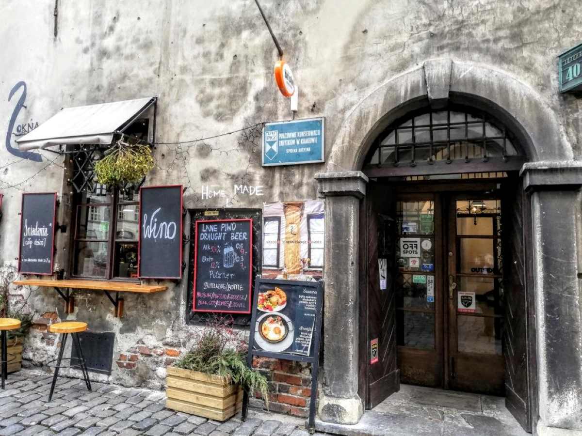 Front of a restaurant in Krakow with menu boards