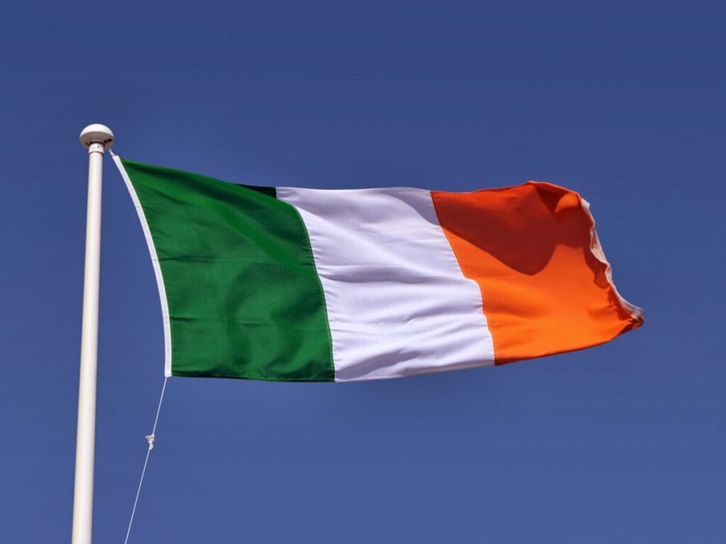 The Irish tricolour flag and blue sky.