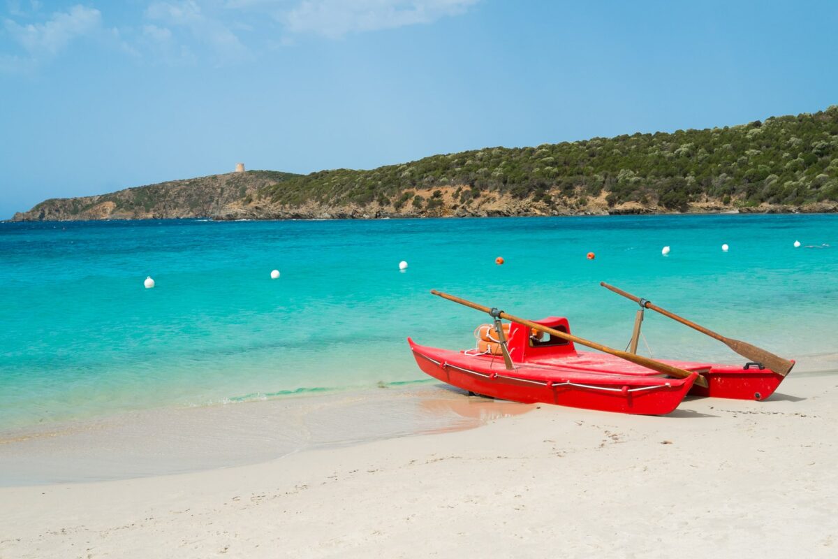 Red rowboat on Tuerredda beach along the coast of Teulada, South Sardinia, Italy