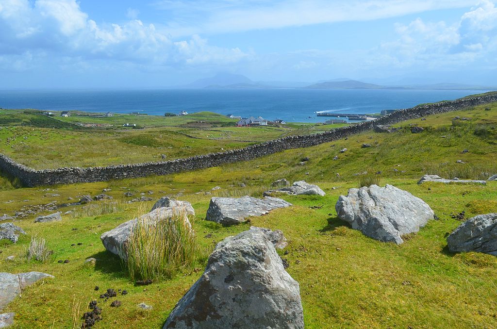 Clare Island - a view of stone walls and rocks covering the island with a view of the water - things to do in Mayo