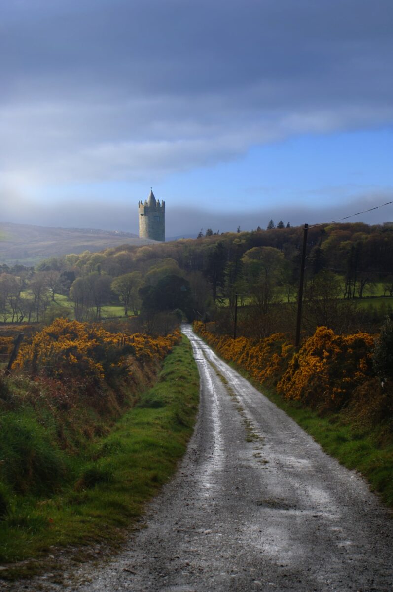 A view of a haunted castle in Ireland through the mist