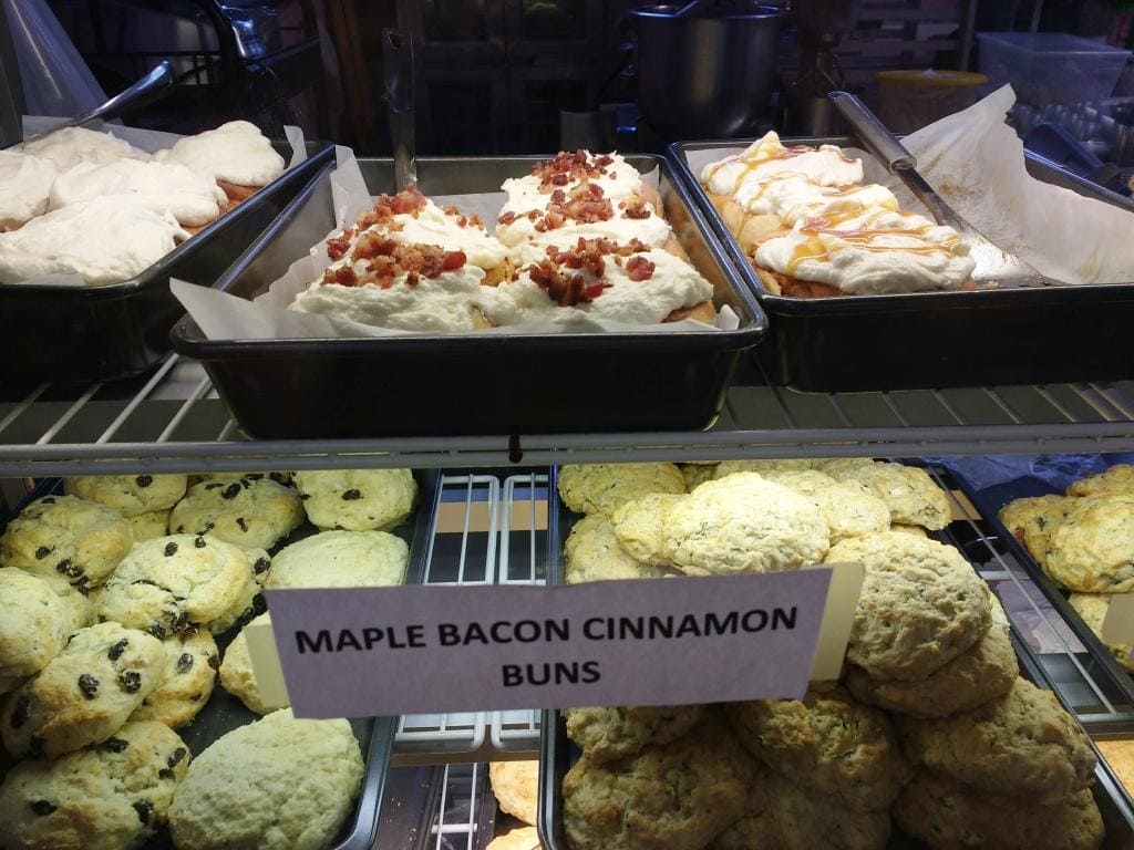 Canadian maple bacon cinnamon buns in a display case.