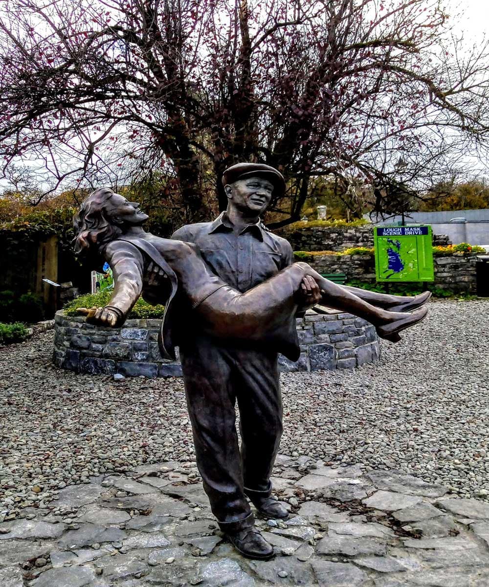 Statue of John Wayne and Maureen O'Hara from the Quiet Man film made in Cong Ireland. Wayne is carrying O'hara in his arems