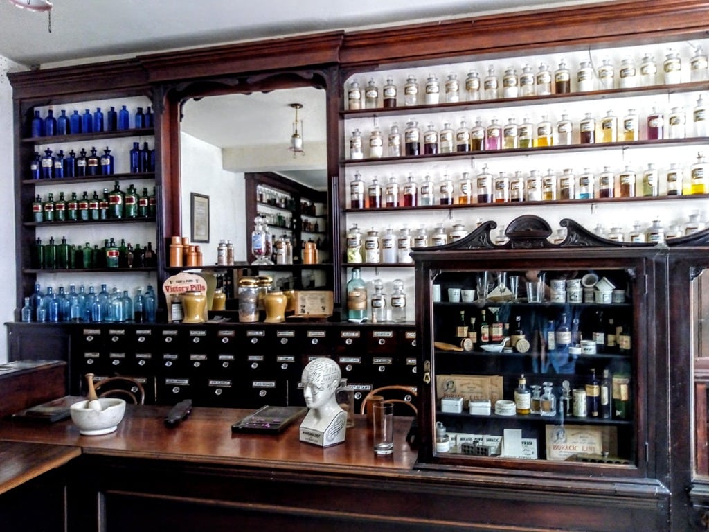 inside the chemist shop on Shop Street within the Ulster American Folk Park showing shelves filled with medicines and placebos