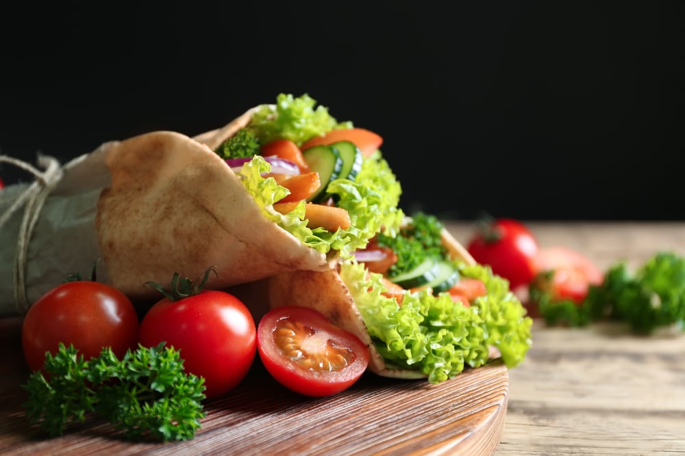 Delicious kebab sandwiches on wooden board