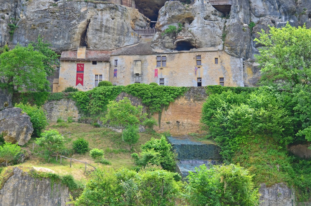 A fortified cave house, occupied from prehistoric times, built into caves in a cliff. Located in the Perigord region of France