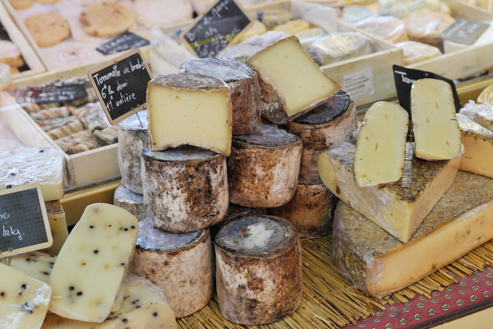 Random types of yellow french cheese at Provence market