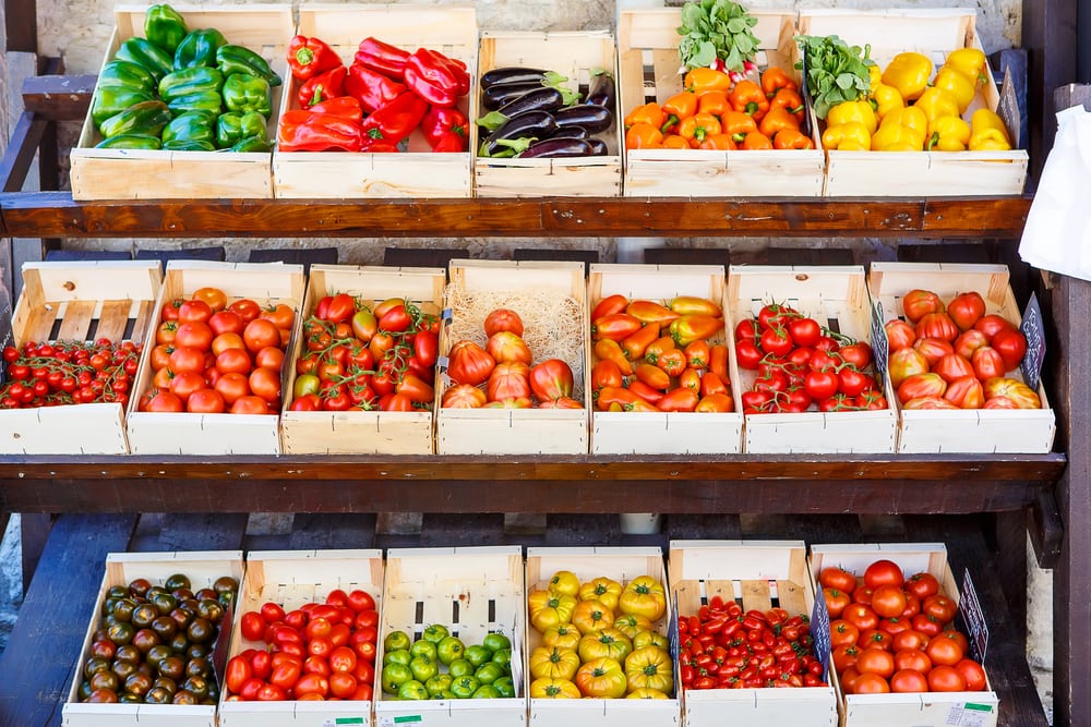 Organic fresh different tomatoes from mediterranean farmers market. Healthy local food market. Variety of tomatoes: green, red, yellow, black. Market in Gordes, Provence, France.