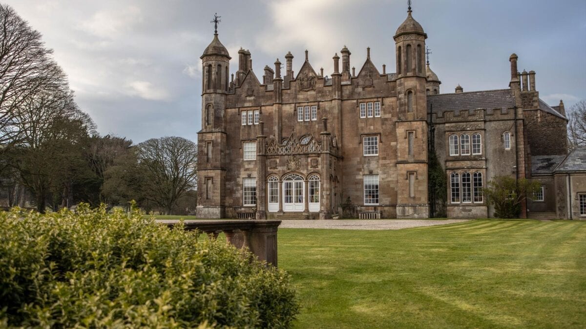 Nestled at the foot of misty Antrim hills, the pink-hued towers of Glenarm Castle overlook a tranquil garden bursting with vibrant rhododendrons