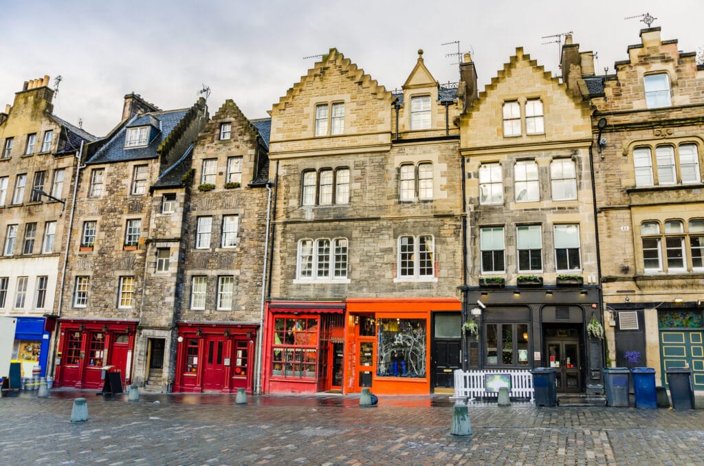 row of colourful shops in the Grassmarket area visit Edinburgh

