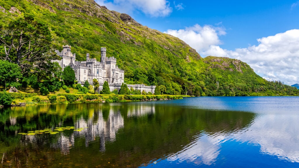 Kylemore Abbey, beautiful castle like abbey reflected in lake at the foot of a mountain. Benedictine monastery founded in 1920, in Connemara, Ireland. Irish movies
