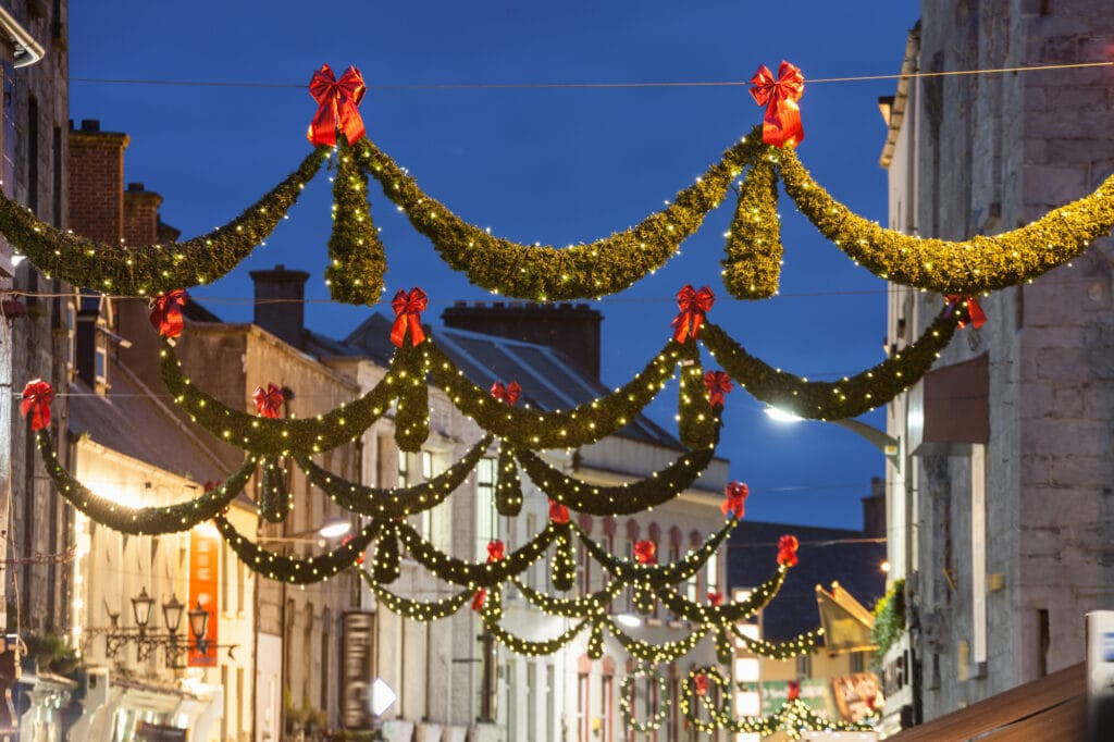 Shop street at night illuminated with Christmas lights, Galway, Ireland