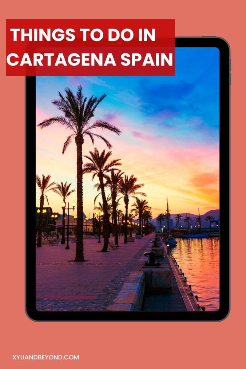 Travel guide displayed on a tablet featuring things to do in Cartagena, Spain with a sunset backdrop.