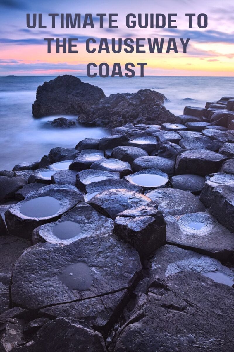 Travel guide cover featuring the rocky shoreline of the Causeway Coastal Route at sunset.